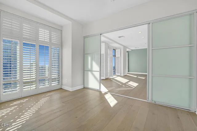 a spacious bathroom with a granite countertop sink a toilet a mirror and shower
