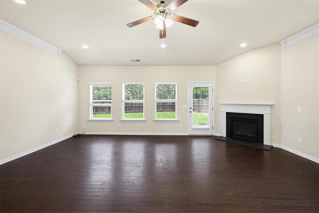 314 Boulder Run Hiram, GA 30141 - Photo 11 of 31 an empty room with wooden floor fireplace and windows
