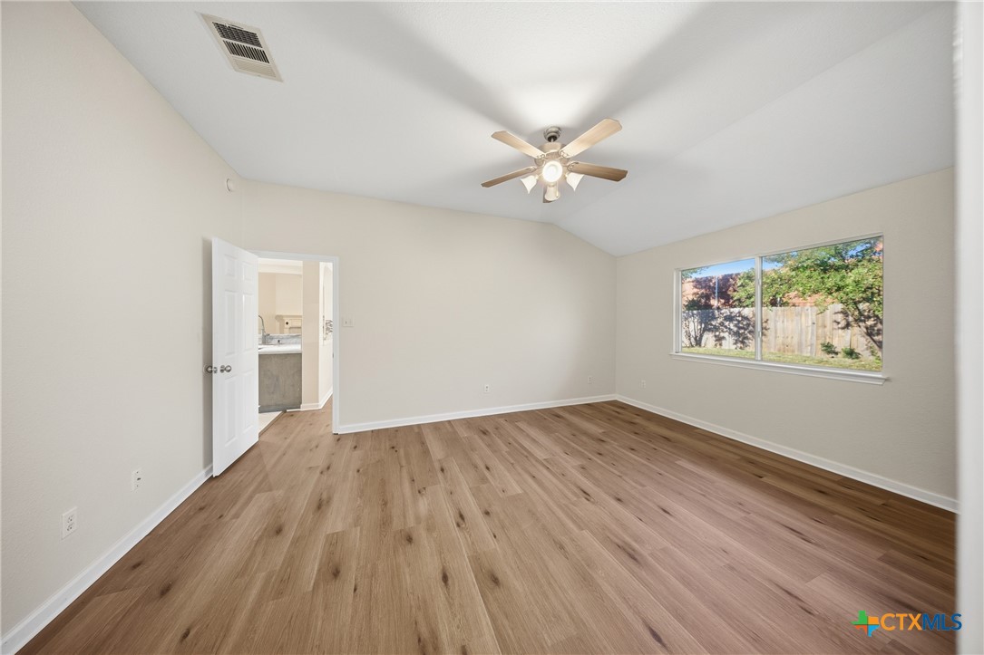 658 Devin Drive Temple, TX 76502 - Photo 19 of 30 wooden floor in an empty room with a window