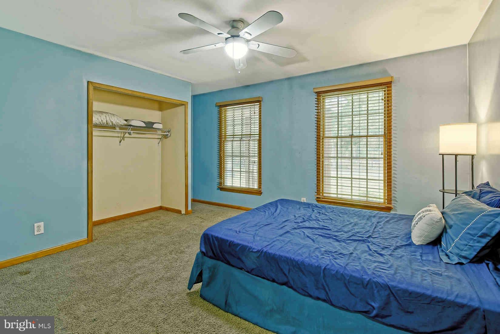 2801 Leaming Mill Road Millville, NJ 08332 - Photo 15 of 34 a bedroom with a large bed and two windows