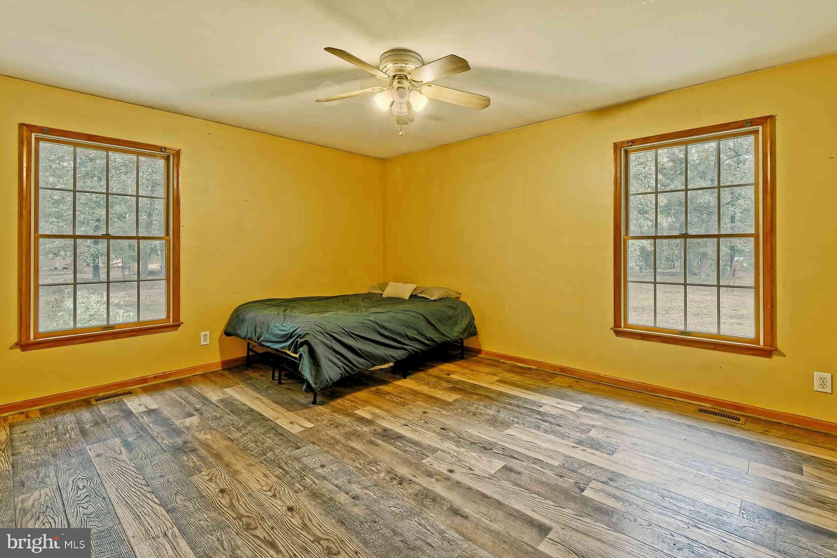 2801 Leaming Mill Road Millville, NJ 08332 - Photo 24 of 34 a bedroom with a bed and wooden floor
