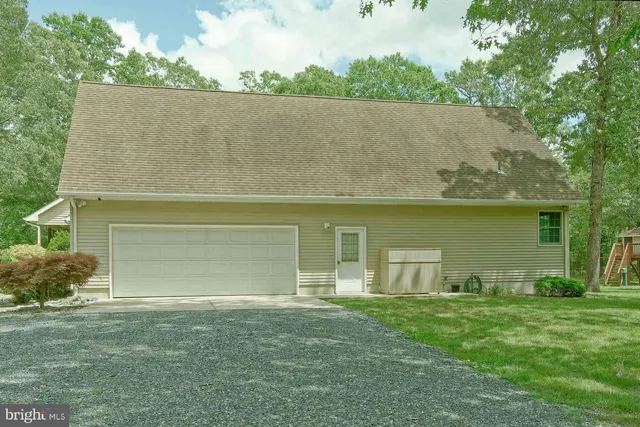 a spacious bathroom with a granite countertop sink and a mirror