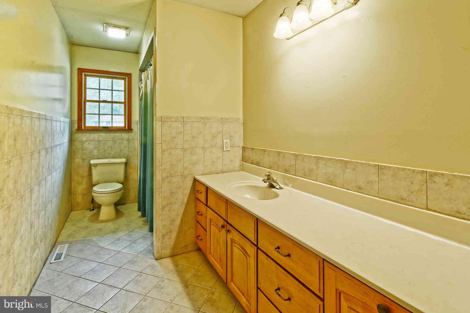 2801 Leaming Mill Road Millville, NJ 08332 - Photo 28 of 34 a spacious bathroom with a granite countertop sink and a mirror