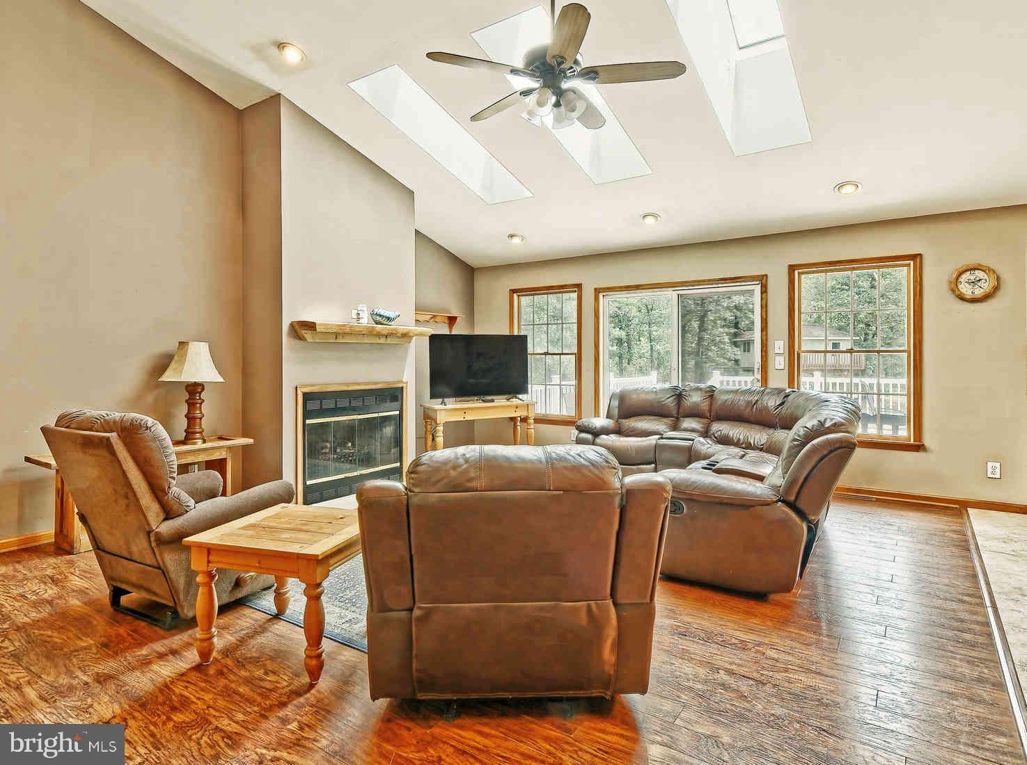 2801 Leaming Mill Road Millville, NJ 08332 - Photo 3 of 34 a living room with furniture a flat screen tv and a floor to ceiling window