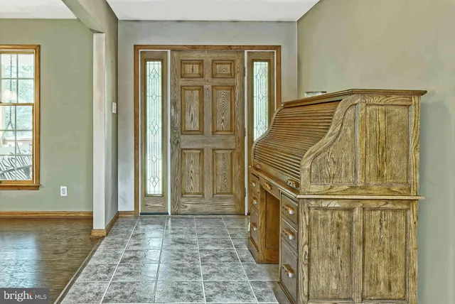 a dining room with furniture and a floor to ceiling window