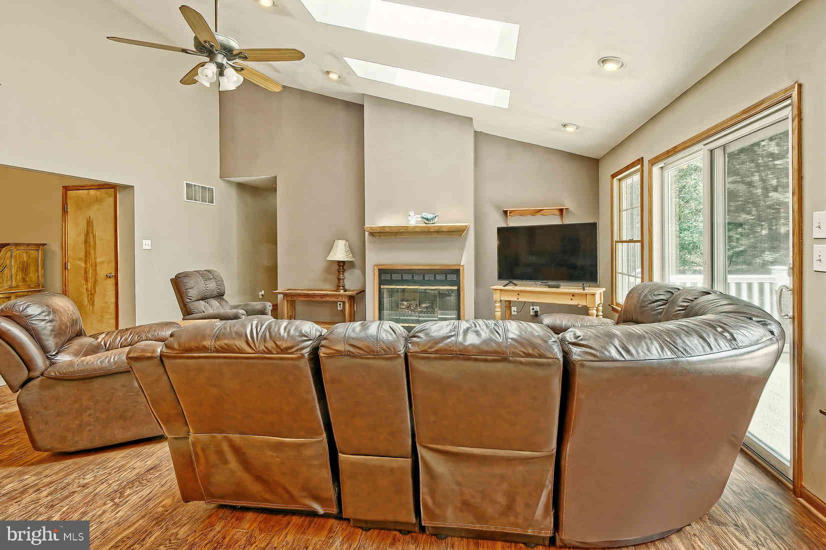 2801 Leaming Mill Road Millville, NJ 08332 - Photo 6 of 34 a living room with furniture a large window and a flat screen tv