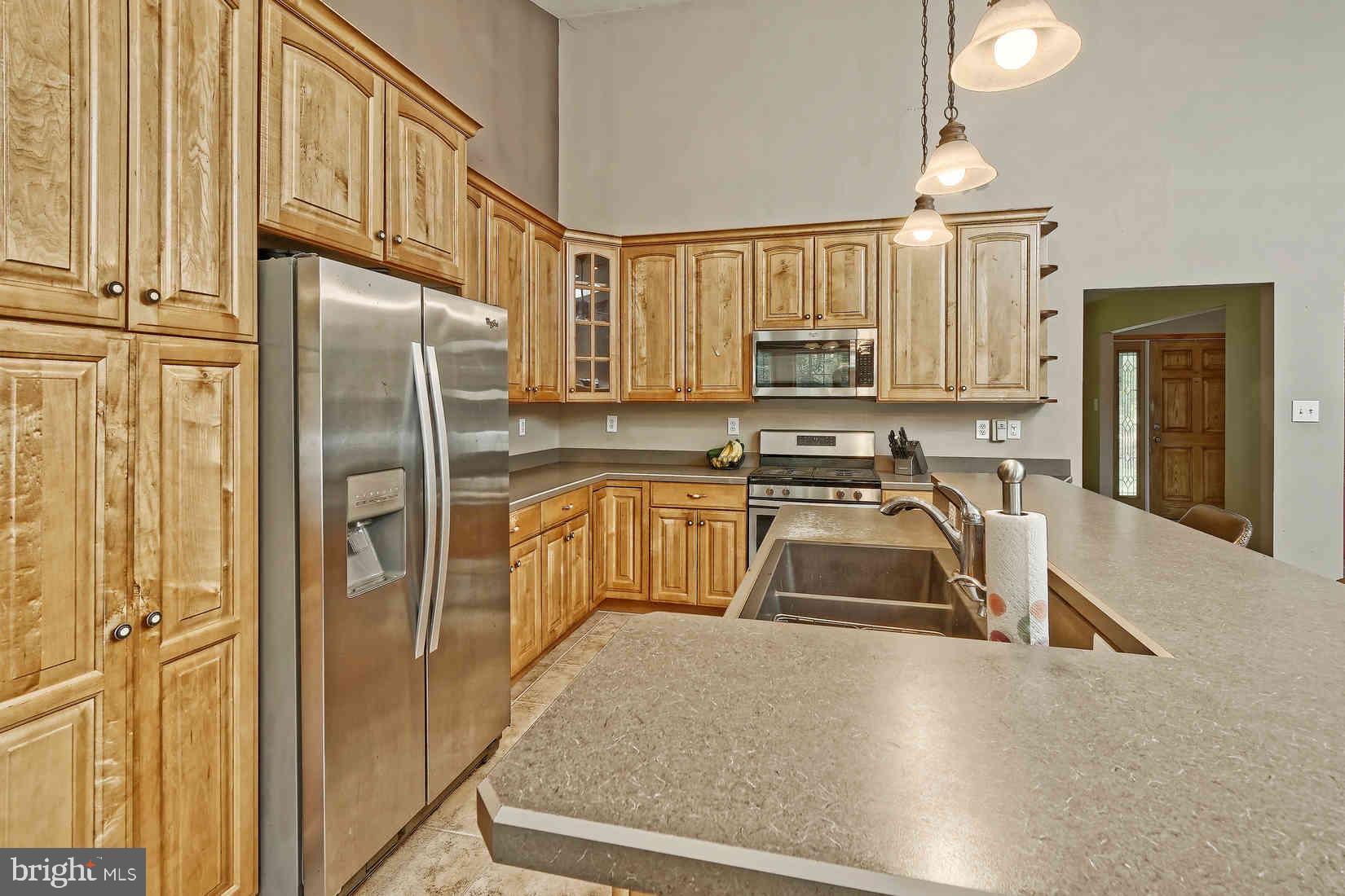 2801 Leaming Mill Road Millville, NJ 08332 - Photo 8 of 34 a kitchen with stainless steel appliances granite countertop a refrigerator a stove and a sink with wooden floor