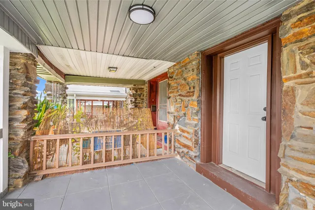 a view of a porch with a table and chairs