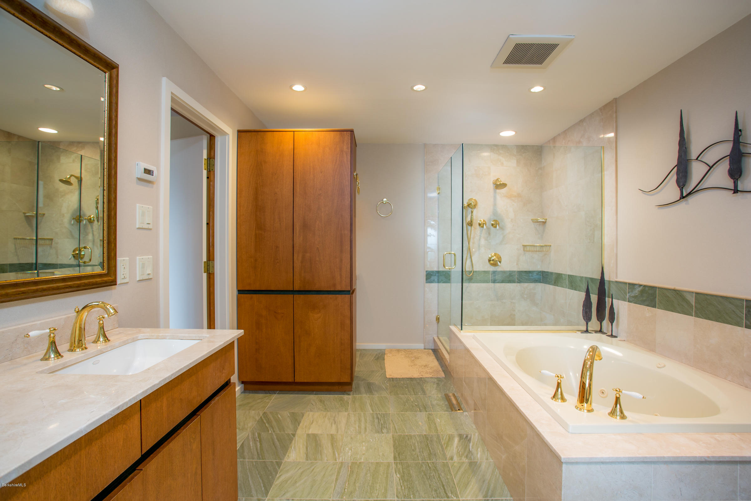 611 Main Road Monterey, MA 01245 - Photo 11 of 32 a spacious bathroom with a tub a double vanity sink and mirror