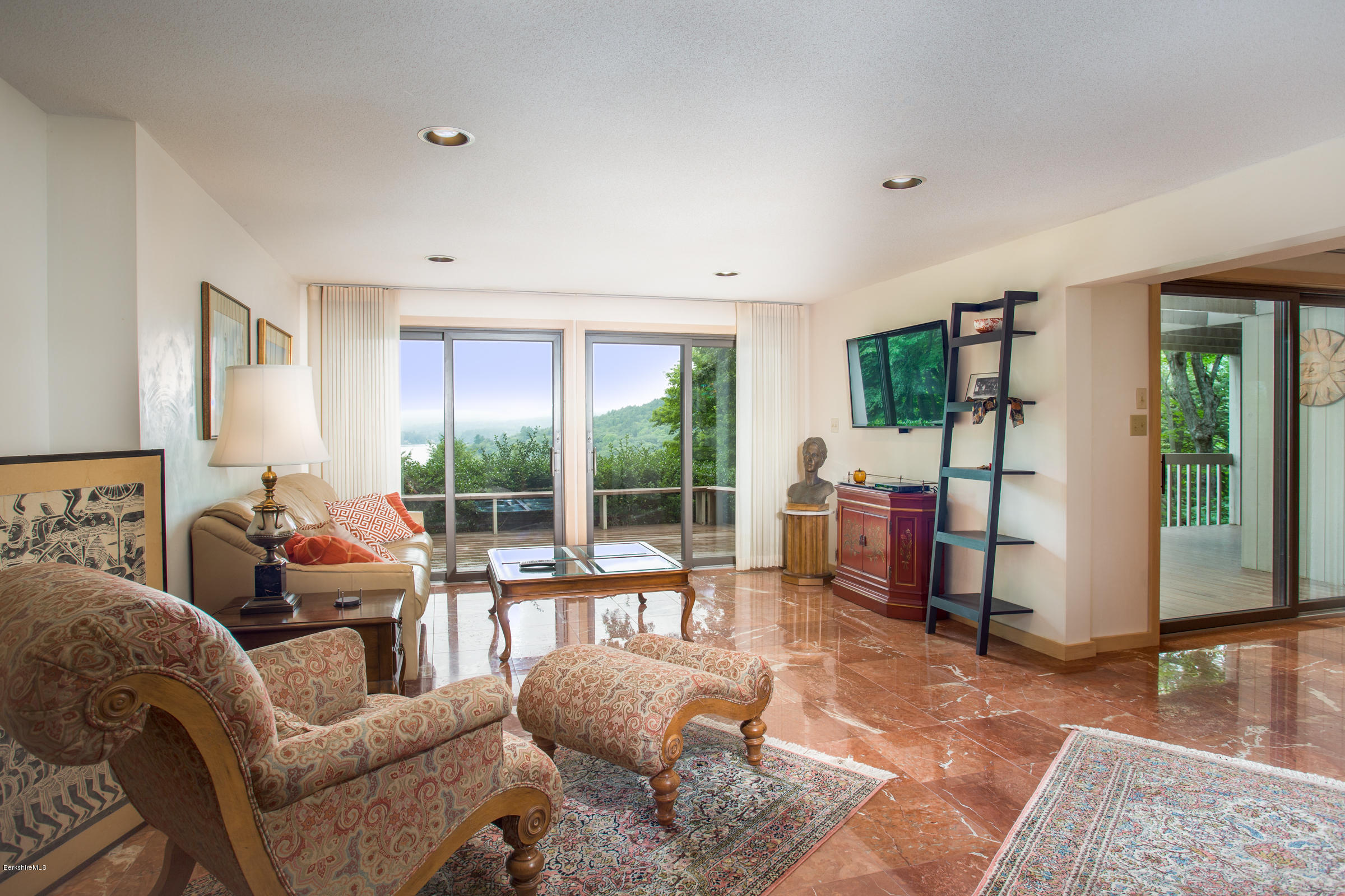 611 Main Road Monterey, MA 01245 - Photo 13 of 32 a living room with furniture tv and a floor to ceiling window