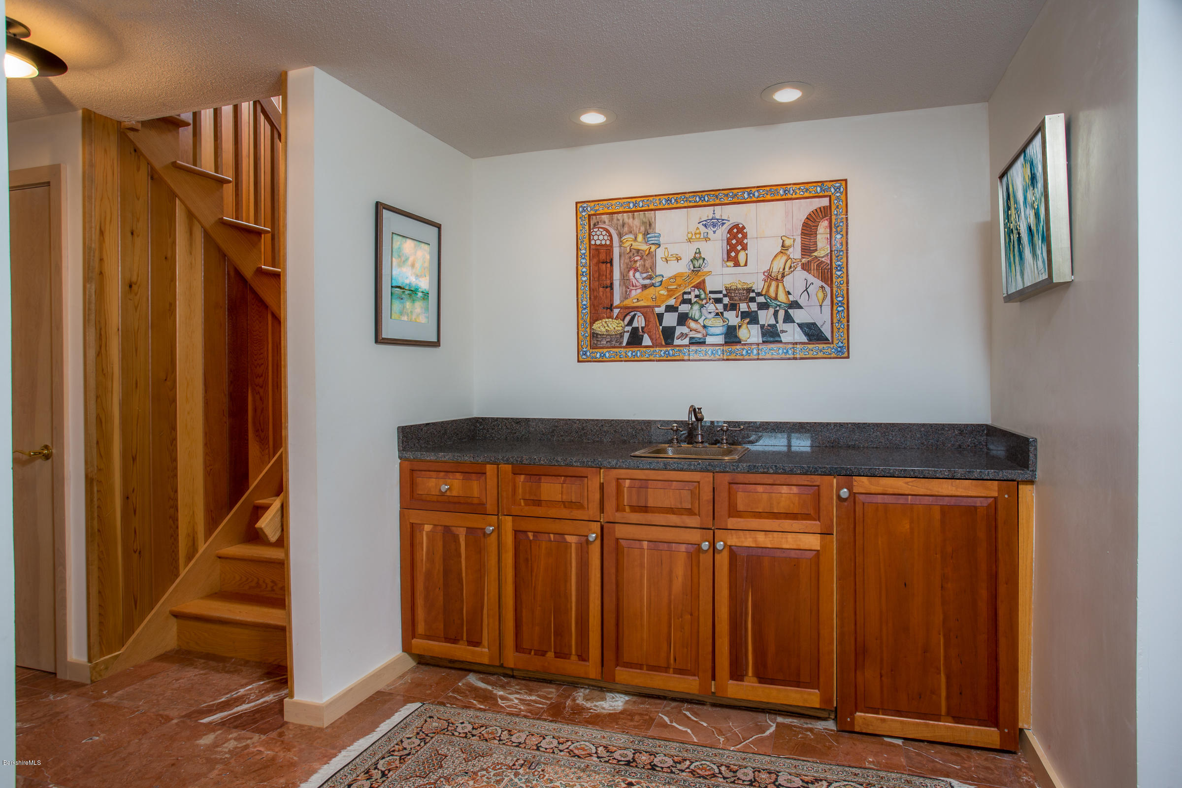 611 Main Road Monterey, MA 01245 - Photo 18 of 32 a view of a hallway with wooden floor and paintings on the wall