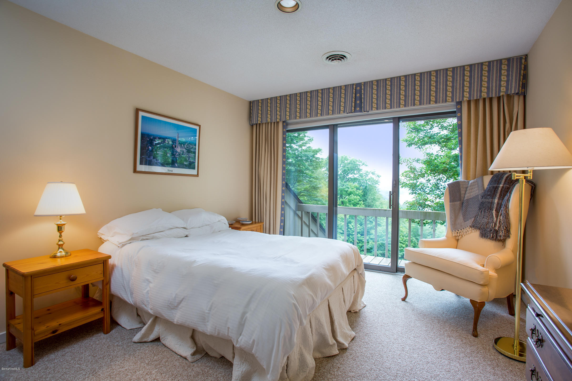 611 Main Road Monterey, MA 01245 - Photo 20 of 32 a bedroom with a bed wooden floor and window