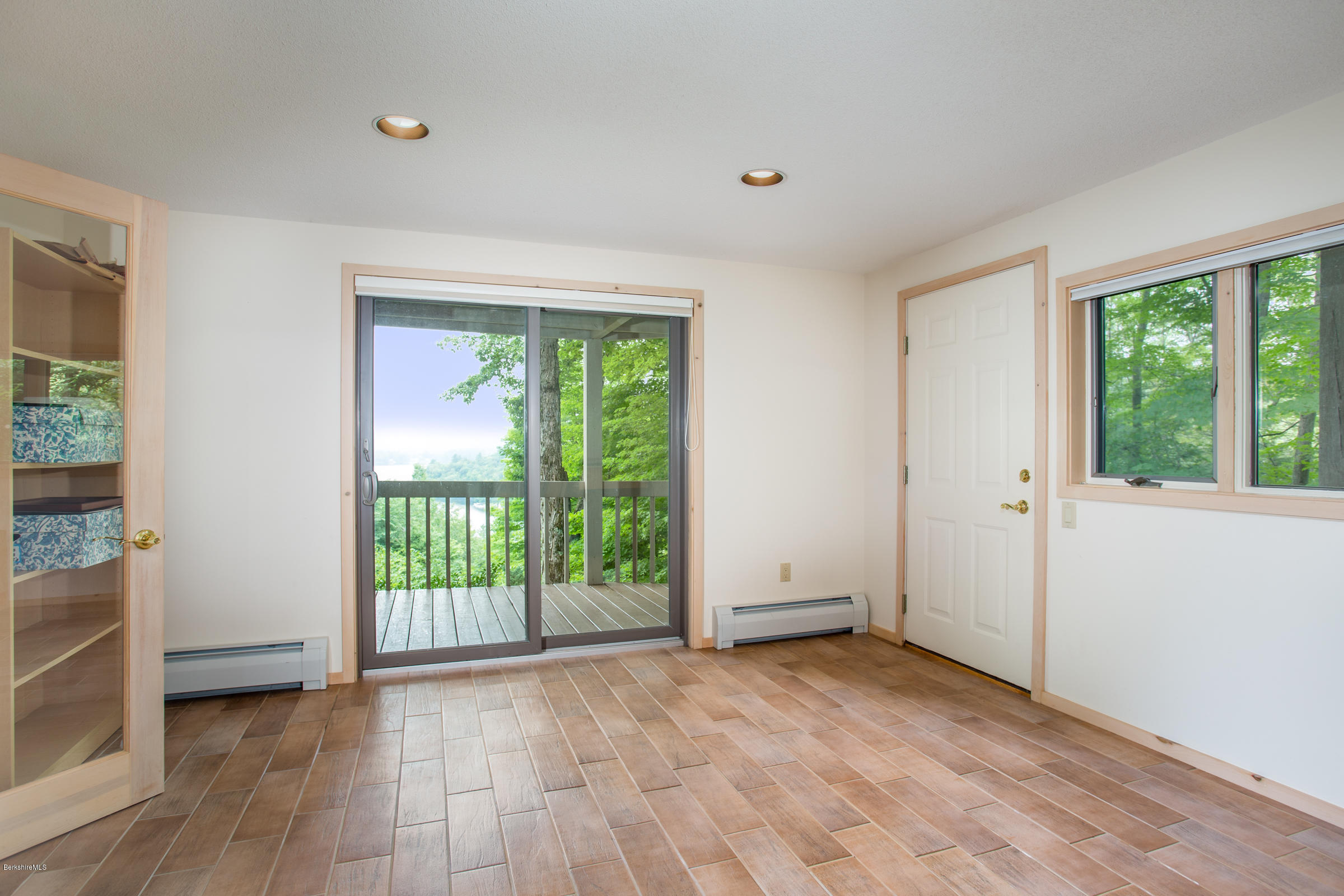 611 Main Road Monterey, MA 01245 - Photo 25 of 32 an empty room with wooden floor and windows