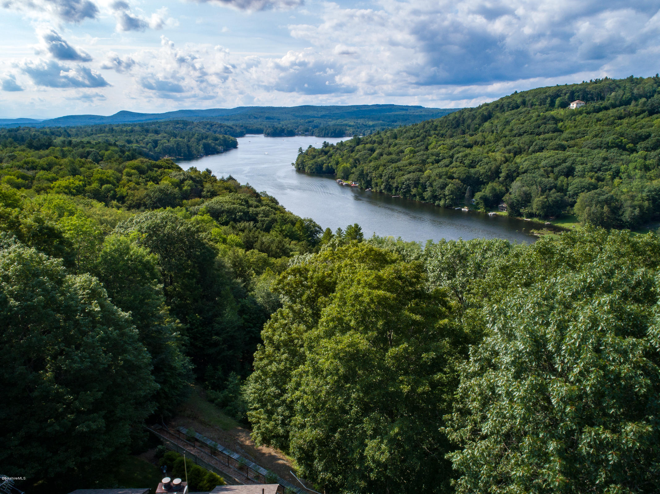 611 Main Road Monterey, MA 01245 - Photo 31 of 32 a view of a lake with a building in the background