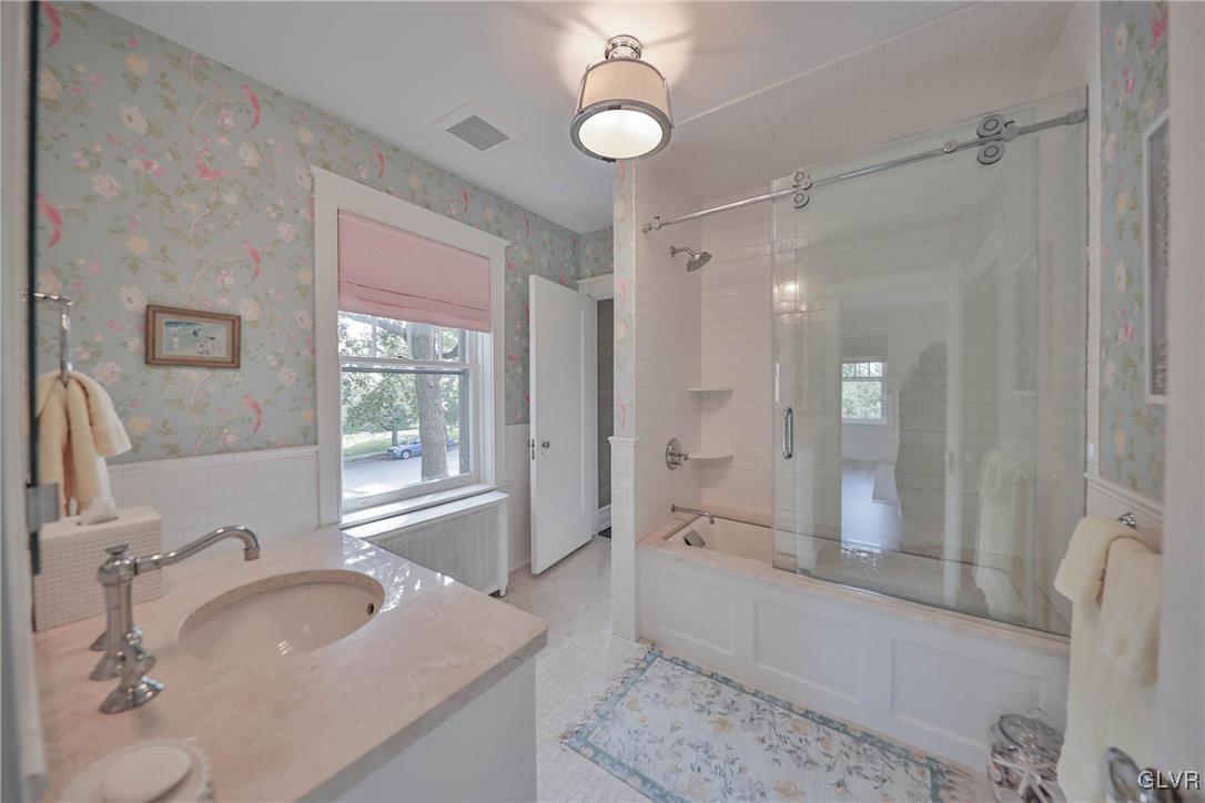 837 Tioga Avenue Bethlehem, PA 18018 - Photo 30 of 50 a spacious bathroom with a granite countertop sink a toilet a mirror and shower