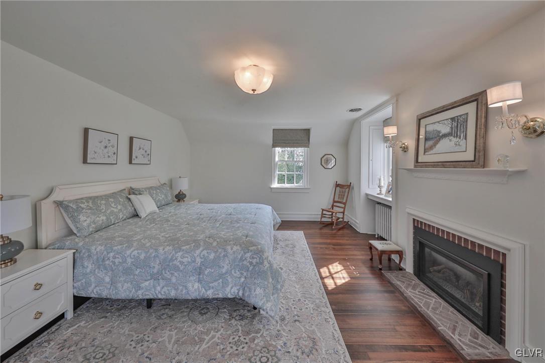 837 Tioga Avenue Bethlehem, PA 18018 - Photo 33 of 50 a spacious bedroom with a bed and a fireplace