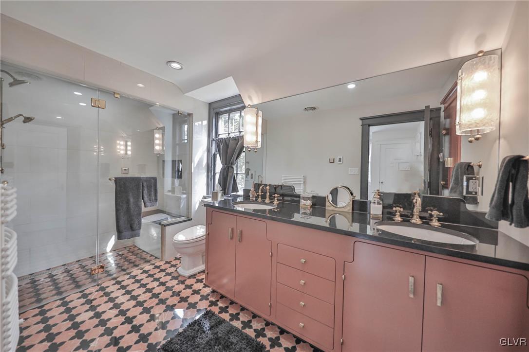 837 Tioga Avenue Bethlehem, PA 18018 - Photo 36 of 50 a large bathroom with a double vanity sink a mirror and a toilet