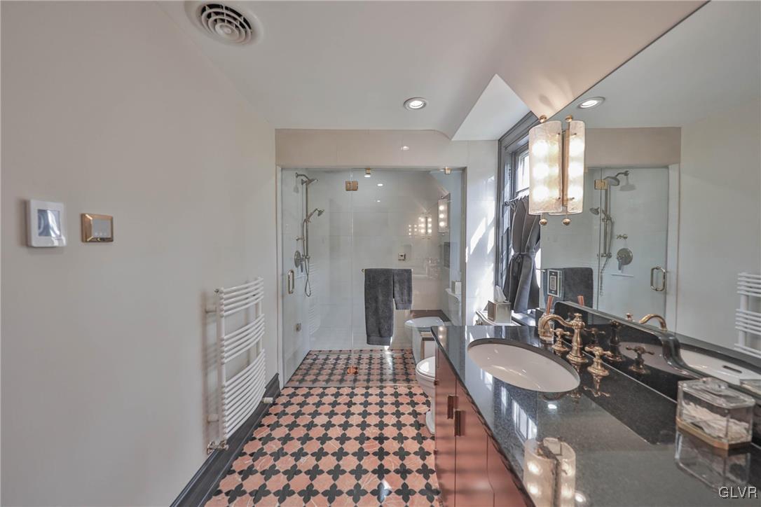 837 Tioga Avenue Bethlehem, PA 18018 - Photo 37 of 50 a bathroom with a sink a mirror and a shower