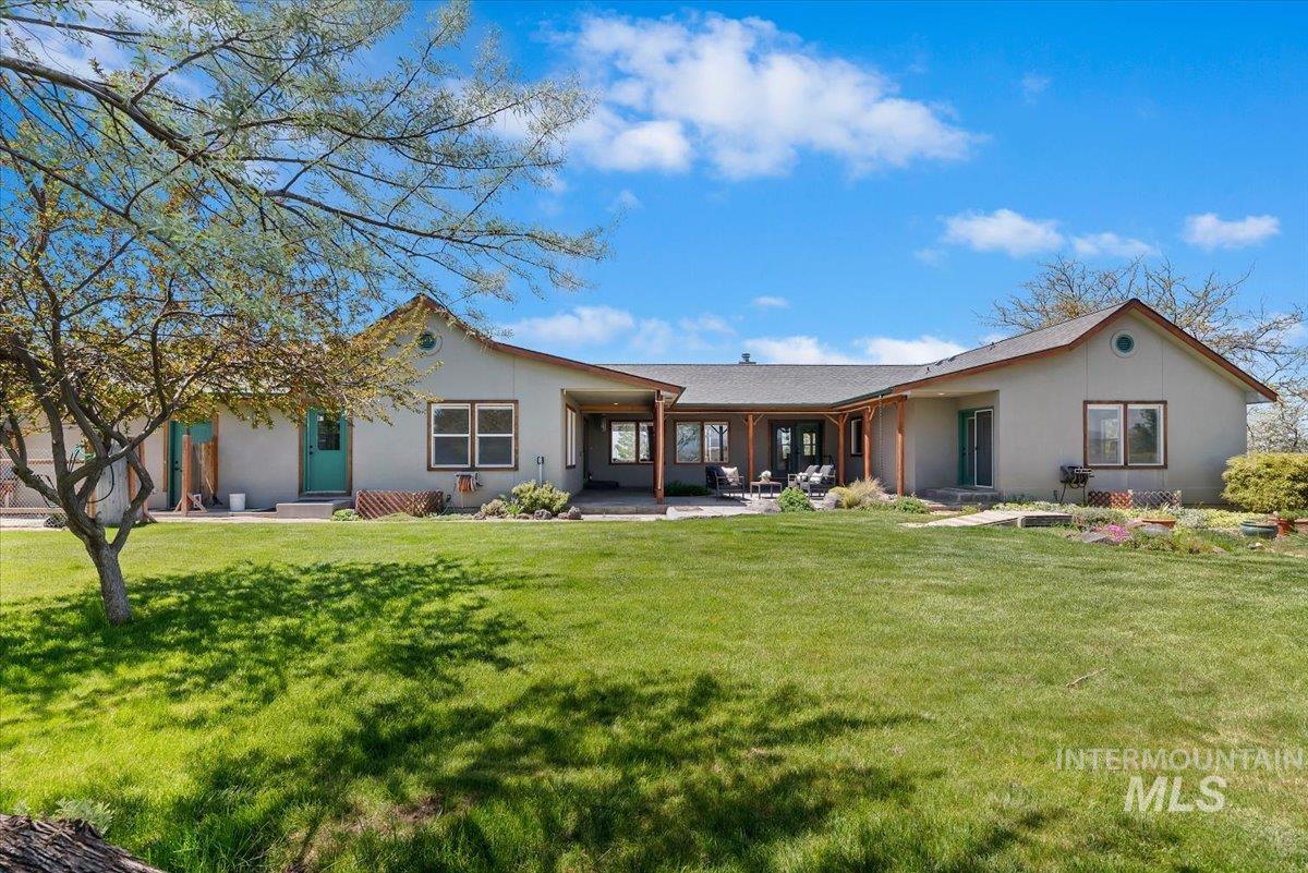 147 East Indian Crk Road Boise, ID 83716 - Photo 31 of 43 Expansive rear exterior with a stucco finish and a pitched shingle roof
