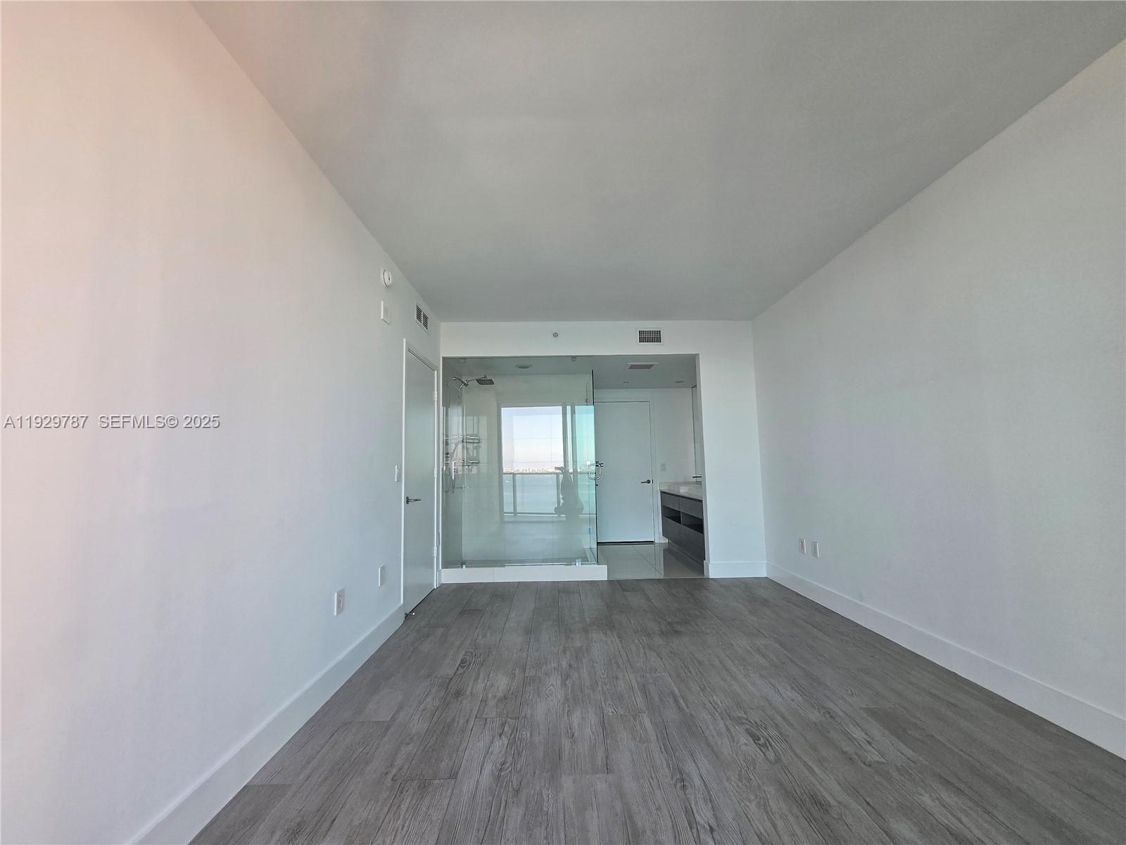 460 Northeast 28th Street, Unit 2407 Miami, FL 33137 - Photo 12 of 50 a view of a big room with wooden floor and a window