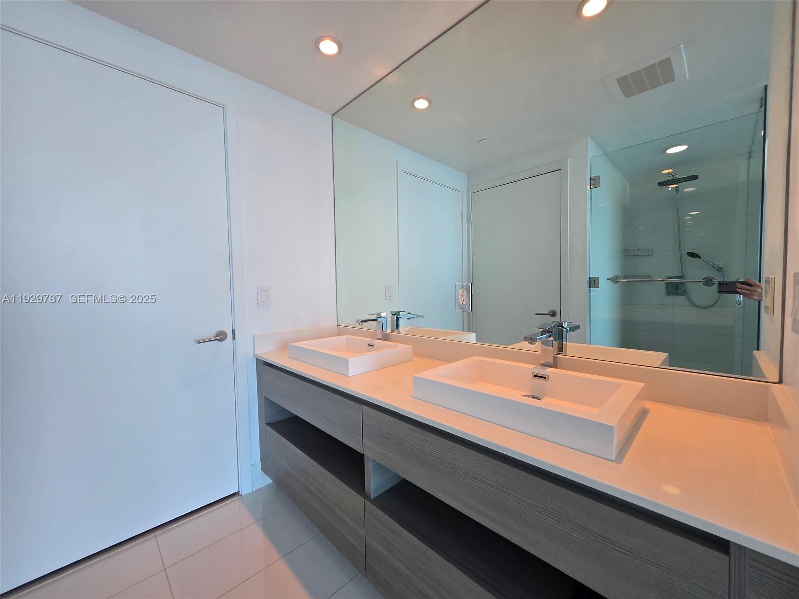 460 Northeast 28th Street, Unit 2407 Miami, FL 33137 - Photo 15 of 50 a bathroom with a sink and a mirror