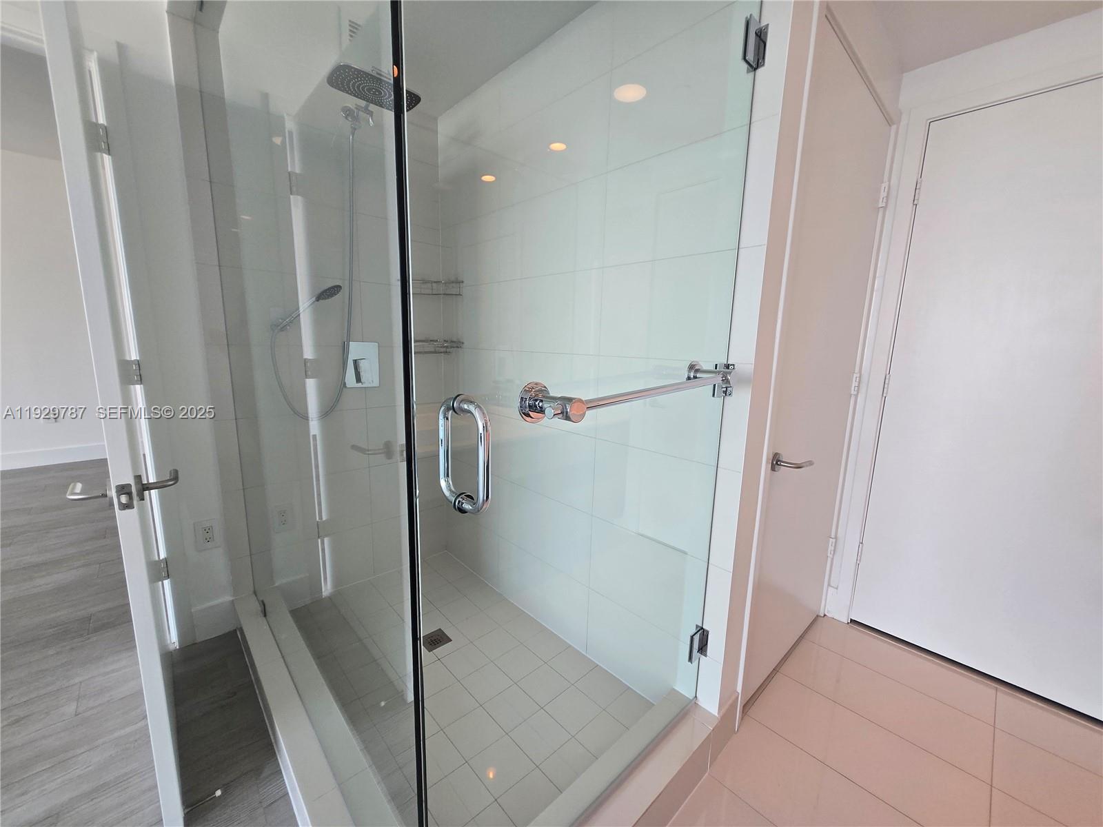 460 Northeast 28th Street, Unit 2407 Miami, FL 33137 - Photo 17 of 50 a bathroom with a glass shower door