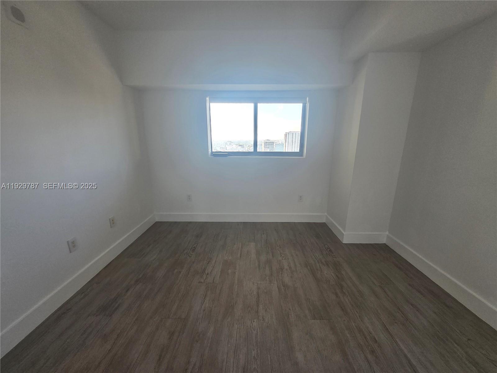 460 Northeast 28th Street, Unit 2407 Miami, FL 33137 - Photo 20 of 50 an empty room with wooden floor and windows