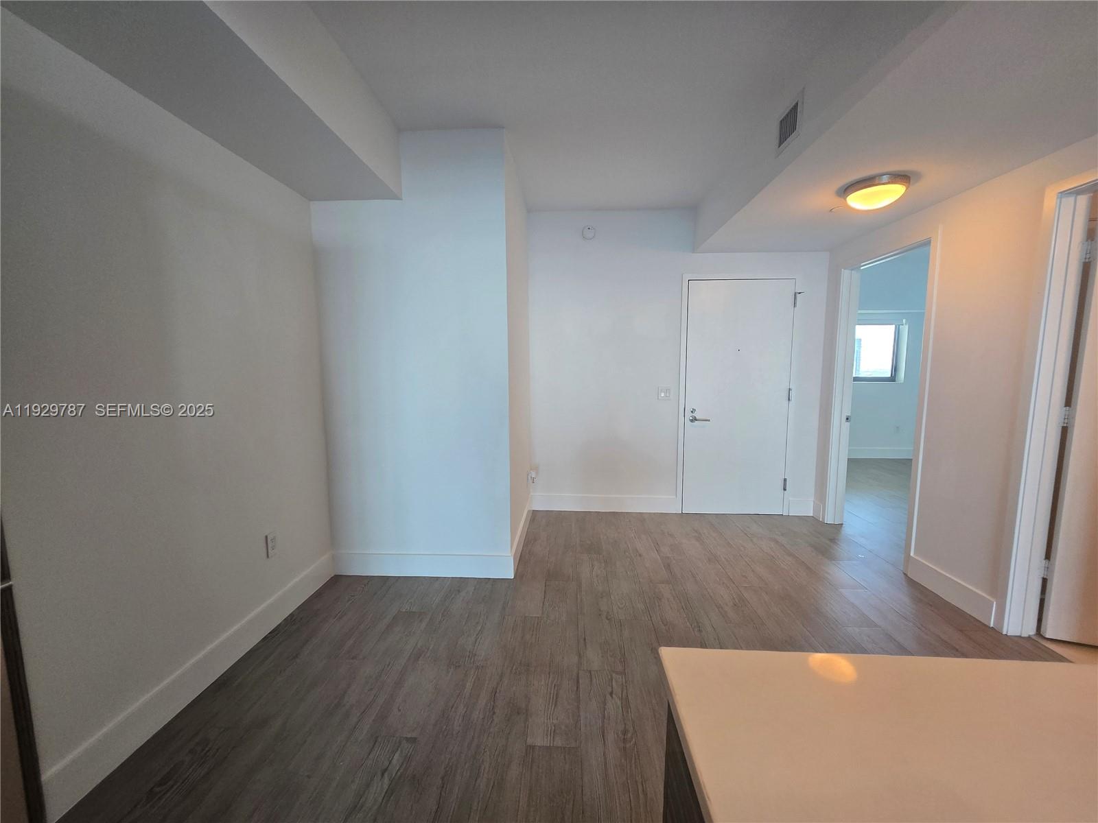 460 Northeast 28th Street, Unit 2407 Miami, FL 33137 - Photo 22 of 50 an empty room with wooden floor