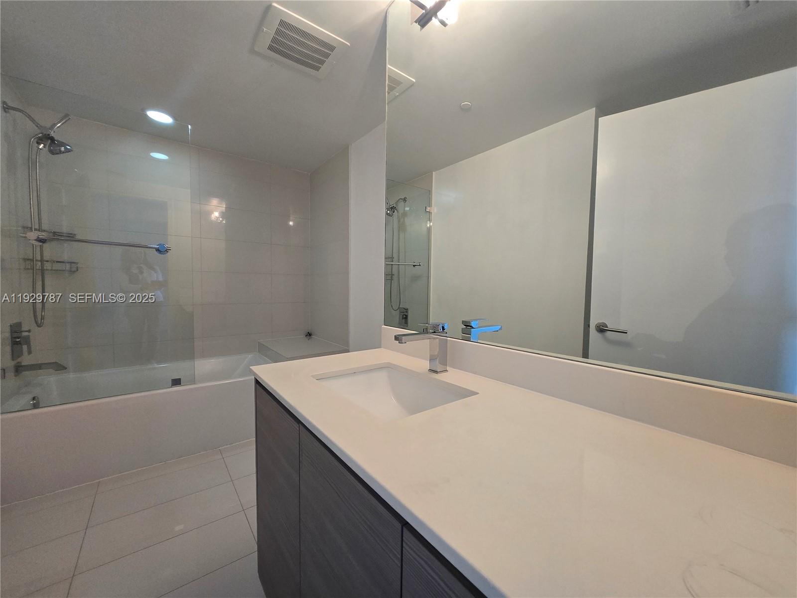 460 Northeast 28th Street, Unit 2407 Miami, FL 33137 - Photo 24 of 50 a bathroom with a sink a toilet and shower