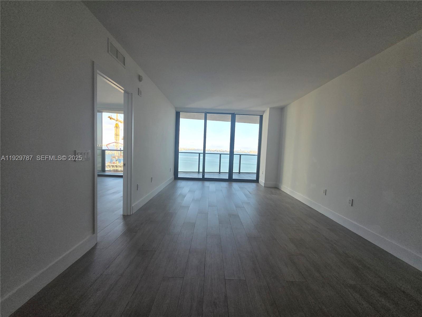 460 Northeast 28th Street, Unit 2407 Miami, FL 33137 - Photo 6 of 50 wooden floor in an empty room with a window