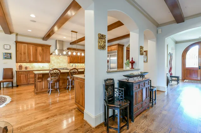 a living room with lots of furniture and kitchen view
