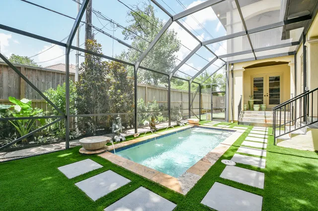 a view of a backyard with swimming pool