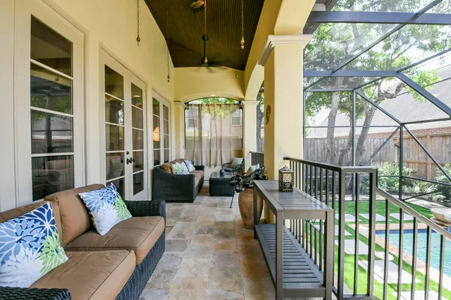 a balcony with furniture and a potted plant