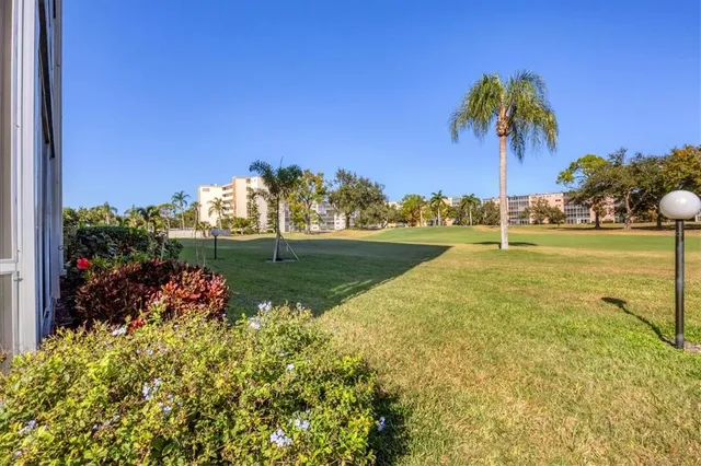 a view of swimming pool with a garden and trees