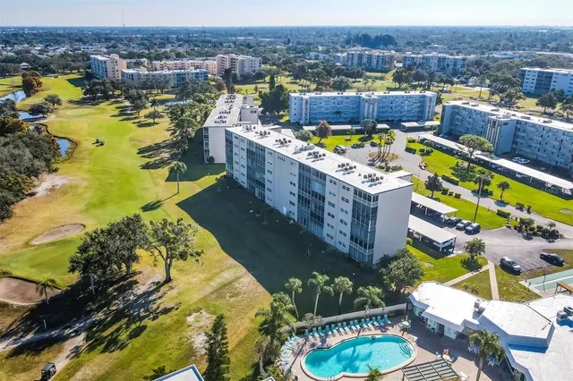 a view of a patio with a table and chairs under an umbrella