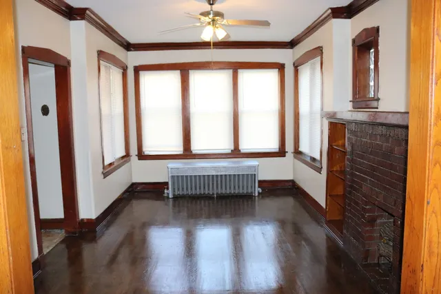 a view of entryway with wooden floor and fan