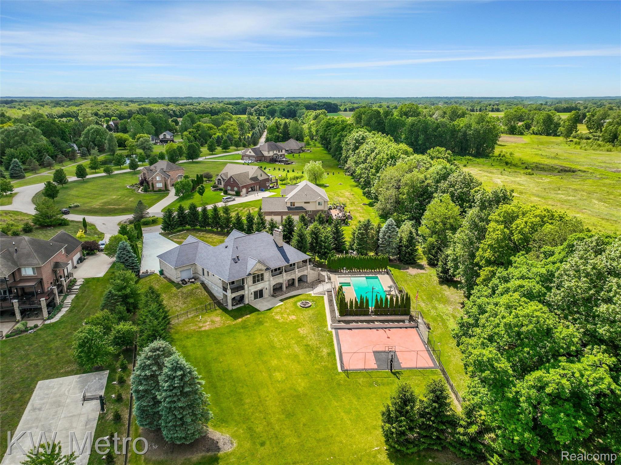 65884 Windrose Court Ray, MI 48096 - Photo 14 of 82 Expansive property featuring a large residence, integrated swimming pool, and dedicated sports court