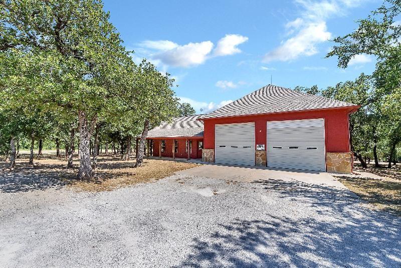 Lot 445 Ranchview Court Bowie, TX 76230 - Photo 11 of 17 a house with trees in front of it