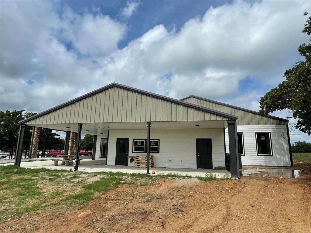 Lot 445 Ranchview Court Bowie, TX 76230 - Photo 2 of 17 a view of a house with backyard porch and sitting area