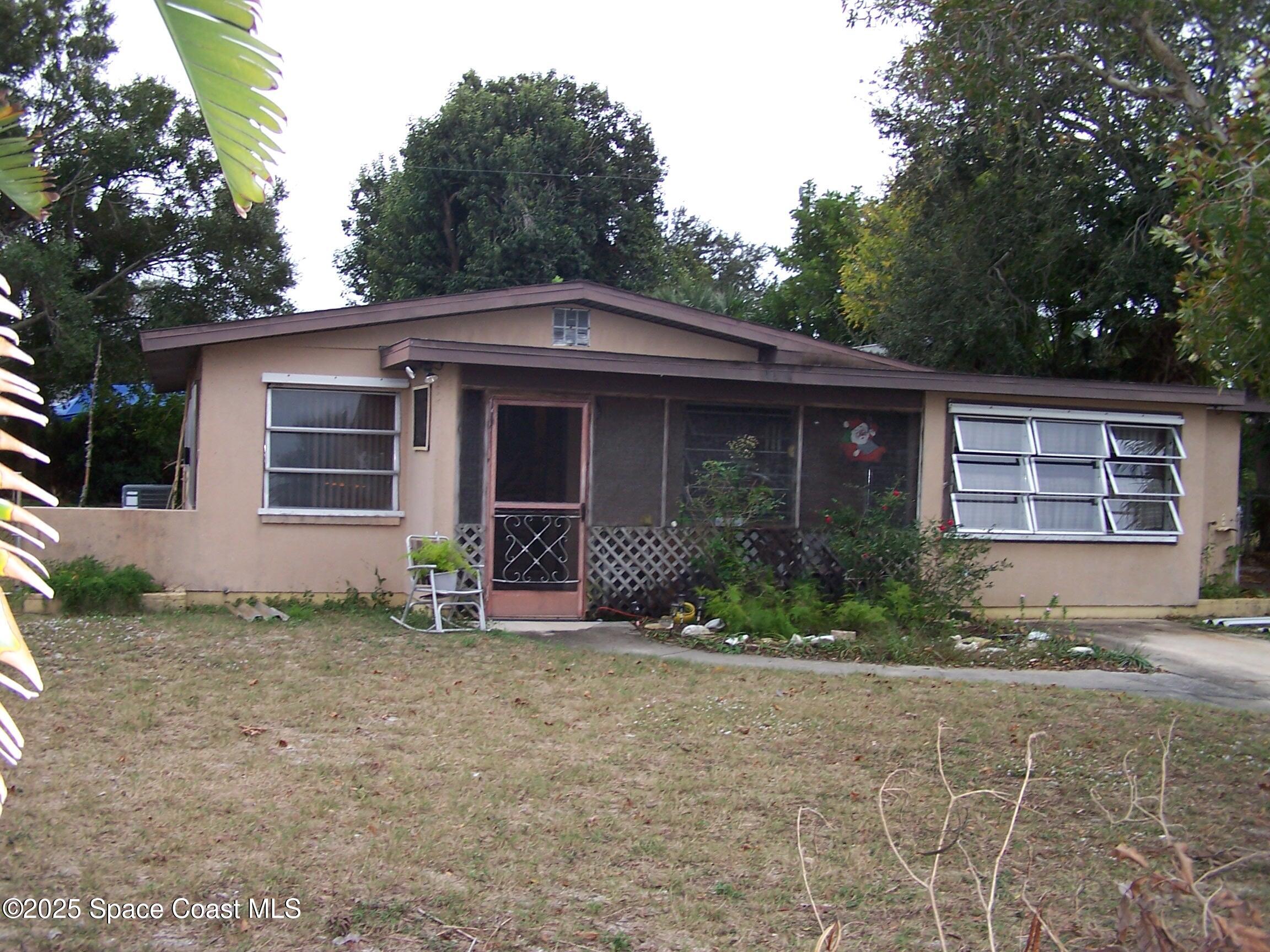1545 Cunningham Avenue Merritt Island, FL 32952 - Photo 1 of 11 a front view of a house with garden