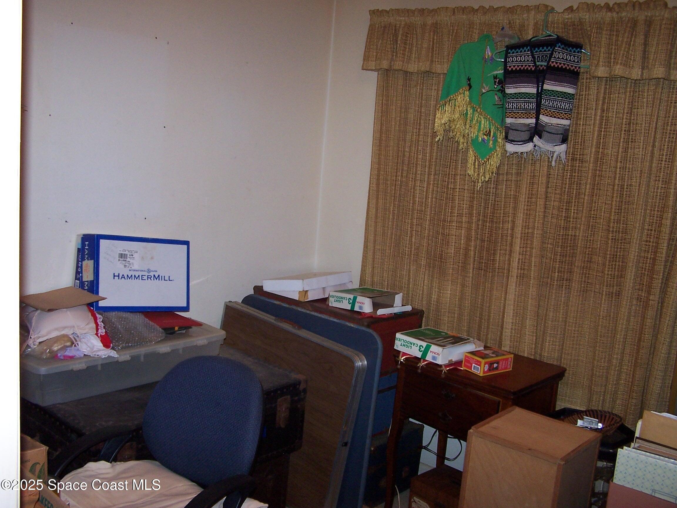 1545 Cunningham Avenue Merritt Island, FL 32952 - Photo 7 of 11 a room with a bed and a furniture