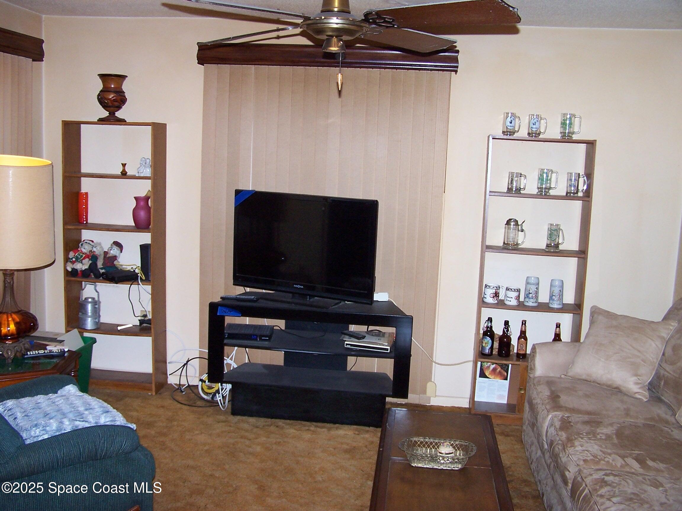 1545 Cunningham Avenue Merritt Island, FL 32952 - Photo 8 of 11 a living room with furniture and a flat screen tv
