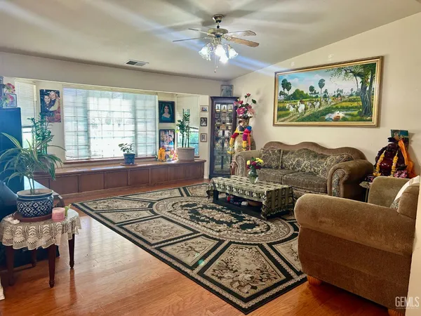 a living room with furniture and a open window