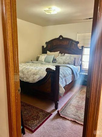 a bed sitting in a bedroom next to a window