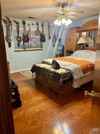 a bed sitting in a bedroom next to a lamp