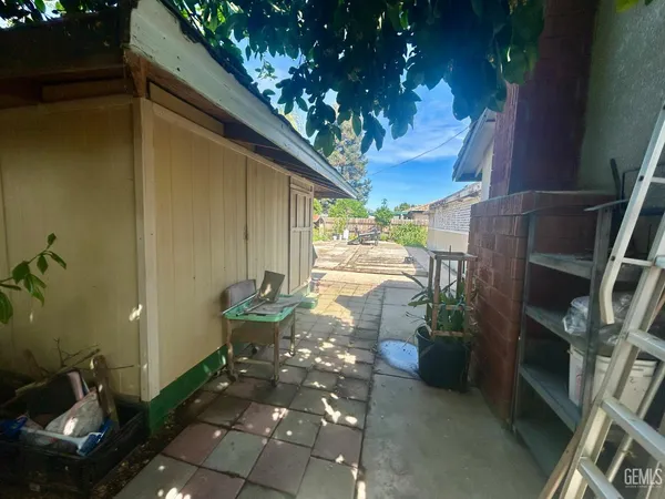 a view of a patio with chairs and potted plants