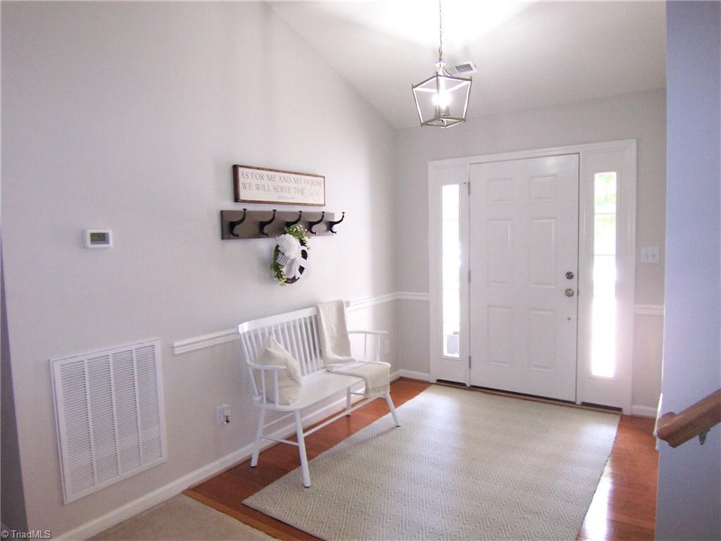 4702 Ridgefall Road Greensboro, NC 27410 - Photo 1 of 27 Bright entry with angled ceilings.