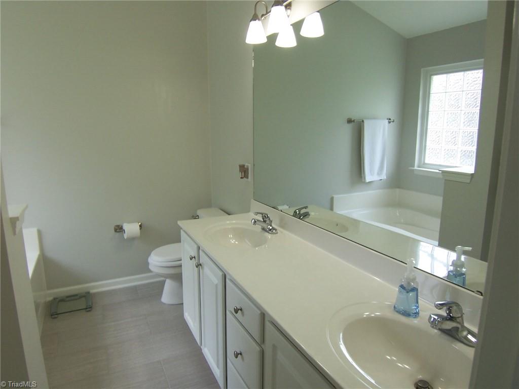 4702 Ridgefall Road Greensboro, NC 27410 - Photo 11 of 27 Double vanity, lots of drawers and cabinets plus separate shower.
