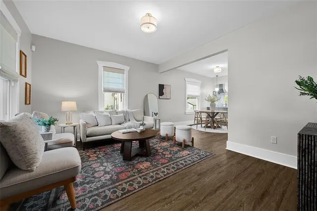 a living room with fireplace furniture and a wooden floor