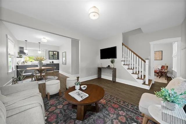 a living room with furniture and wooden floor